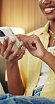Hands, woman and relax in home with phone, social media and text message in lounge. Smile, female person or typing at house with mobile app, browsing website and online notification for chat response