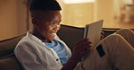 Tablet, success and happy child in home with game, score points and online entertainment. Technology, smile and African boy in living room for gaming on internet, play or victory achievement at night