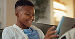 Happy, child and relax with tablet in living room, scroll and watching movie on website in apartment. Streaming, film and black kid with tech in lounge, break and smile with app subscription in house