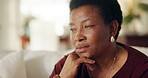 Woman, senior and thinking on couch at house, contemplating or daydreaming with wonder. Female black person, mature and perspective, nostalgia or remember with memory, insight or reflection at home