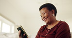 Laugh, message or black woman in house with phone, digital communication or comic post on social media. Space, low angle and mature person in home with tech, funny text or meme reaction on chat app