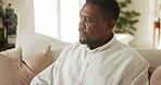 Man, thinking and remote work on couch with laptop, financial planning or check website for tax return. Black person, freelancer and browsing in home with computer, problem solving or finance review.