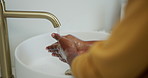 Hygiene, person and washing hands with soap in bathroom for germ removal, disinfection and cleanliness. Skincare, water and cleaning dirt in sink for bacteria safety, healthcare and wellness in home