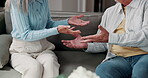 Argument, fighting and hands with couple on sofa in home for conflict or disagreement. Anger, relationship and stress with unhappy people in apartment for blame, frustration or marriage mistake