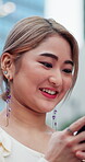 Woman, phone and texting in city, smile for online feedback or social media comment with technology. Happy, typing and Asian person in urban outdoor, mobile app or connection with message on internet
