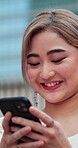 Woman, phone and texting in city with thinking for online feedback or social media comment with technology. Happy, typing and Asian person with ideas outdoor, app or connection with message on web