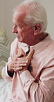 Chest pain, old person and thinking in home with massage, hypertension and symptom of cardiac arrest. Senior man, retirement and worry in house with heartburn, chronic illness or cardiovascular issue