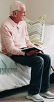Senior man, thinking and bible in home, religion and worship with holy scripture or spiritual belief. Praise, God and pensioner with book for Christianity, knowledge and Jesus Christ guidance on bed