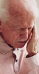 Old man, headache and stress in house with pain, hypertension and massage temples for relief. Senior person, discomfort and migraine in retirement home with tension, pressure or upset for memory loss