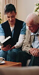 Reading, bible and caregiver with senior man, faith and worship with scripture and spiritual belief. Assisted living, home and old person with book for religion, knowledge and Jesus Christ guidance