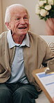 Happy, elderly man and discussion with psychologist in office, therapy and mental health assessment. Psychology, consultation and senior person with smile, therapist and evaluation with clipboard