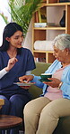 Caregiver, tea and cookie for senior woman on house sofa for elderly care, homecare or assisted living. Happy, warm beverage of biscuit for old person with carer in retirement home for wellness
