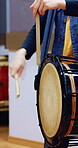 Taiko, practice or hands in class with drums, traditional training or audio coordination in performance. Percussion, rhythm or person with instrument, synchrony rehearsal or music lesson in Japan.