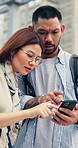 Couple, travel and phone in city with map, tourist guide or search direction for holiday adventure. Japanese people, dating and talk outdoor in urban town with tech, location app or vacation in Tokyo