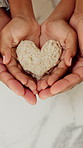 Parent, child and hands with heart for sandwich, healthy nutrition and support for wellness in home. Kitchen, family care and kid with love symbol for bread snack, food or bonding together from above
