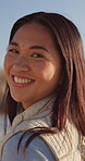 Smile, travel and face with woman at beach for summer vacation, sunset and ocean getaway. Happiness, seaside trip and happy with person outdoor for holiday, weekend break and tropical island