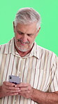 Phone, smile and typing with man on green screen background for communication, feedback or update. App, happy and text message with mature person in studio for download, mobile post or search