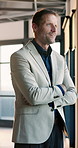 Happy, businessman and thinking in office with arms crossed, idea or satisfaction for company growth. Mature person, smile and reflection in workplace with confidence, vision and optimism for career.