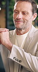 Happy, businessman and typing in office with laptop, reading email and good news for budget report. Mature person, smile and thinking in agency with computer, financial planning or positive feedback.