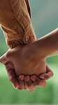 Couple, holding hands and love in marriage outdoor with commitment, support and companion or partner. Man, woman and relationship with care, belonging and connection with trust, safety and security
