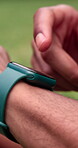 Finger, fitness and smart watch with person outdoor for performance or progress tracking closeup. App, exercise tracker and hand of runner in park for health, morning challenge or wellness activity
