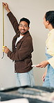 Measuring, happy and couple in new home for renovation, remodeling and real estate investment. Man, woman and laugh together in house with wall length, tape and property for interior design
