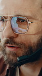 Call center, telemarketer and man with headset, chat and discussion with contact for lead generation. Telemarketing, consultant and person with glasses, listening and communication with mic in office