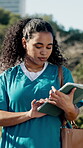 Nurse, scroll and woman with tablet at park, student and academic project preparation with research. City, clinical trainee and person with tech for medical report, study and browsing healthcare info