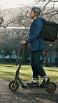 Outdoor, delivery man and  travel on electric scooter, logistics and commuting with ecommerce order. City, courier and person with backpack on transport, shipping and distribution service with bike
