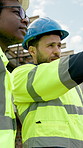 Men, team and meeting on construction site for planning, property development and discussion. Engineer, infrastructure safety and people at building worksite for project management or remodeling