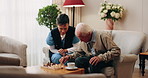 Senior, man and chess in nursing home with caregiver, moving pawn and happy for bonding together. Nurse, elderly person and problem solving with board game, cognitive skills and retirement wellness.