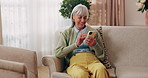 Phone, happy and senior woman on sofa in home for texting, notification or social media. Smile, relax and elderly person with cellphone for reading blog, update or email on mobile app in living room.