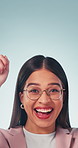 Pointing, smile and face of businesswoman in studio by mockup space for marketing or advertising. Glasses, happy and portrait of financial advisor with promotion of investment on blue background.