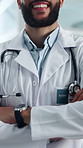 Happy, doctor and arms crossed in hospital, healthcare and confident for medical service or medicine. Clinic, health professional and person with smile, wellness and pride for career development