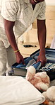 Packing, dad and child in home with suitcase for travel, vacation and prepare for holiday. Black family, happy and kid with clothes, toys and help father with luggage for  adventure, getaway and trip