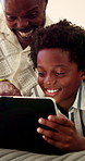 Boy, surprise and tablet with father pointing in bedroom of home for bonding or connection. App, excited and streaming son with dad on bed in apartment for development or subscription as black family