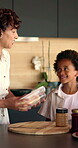 Mother, sandwich and school lunch in kitchen of home with son for nutrition or snack. Making food, meal preparation and student with African woman packing bread for happy boy child in apartment