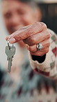Hands, old woman and keys outdoor at new house, property purchase and smile for relocation. Face, senior person and entrance at front door for moving in, homeownership and investment for real estate