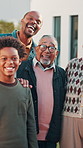 Happy, face and family in front yard with kids for moving to dream house, property and home. Portrait, generations and senior people, parents and children for bonding, love and security with mortgage