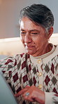 Mature, woman and scroll in home with tablet, reading ebook and browsing website for digital news. Person, relax and tech in house with internet connectivity, search article and app for online story.
