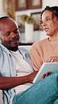 African couple, smile and tablet on sofa for typing, streaming or subscription in living room. Man, woman and movie choice in house together for weekend, bonding and love with digital tech in lounge