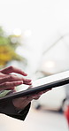 Tablet, hands and business person outdoor for online communication, real estate listing or post. Tech, internet and agent typing with app for property development, scroll or rental email with rain