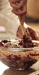 Baking, hands and mixing ingredients in house for chocolate cake, recipe process or culinary hobby. Baker, person and cocoa mixture in kitchen for handmade cookies, dessert and cupcake preparation