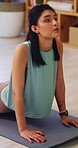 Yoga, stretching and woman on mat in house, zen and physical activity to improve posture and health. Person, breathing and self care with cobra pose, fitness and warm up routine with balance in home
