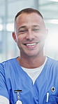 Face, nurse and happy man with pride in hospital for medical assistance, help or advice. Portrait, male person or healthcare worker with smile, lens flare or confidence for health support in clinic
