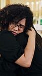 Funeral, hug and family in church with support, comforting and remembrance with mourning. Sad, empathy and women at coffin with coping embrace, emotional moment and shared grief at memorial service.