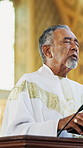 Altar, praying and pastor in church for sermon, blessing or gospel to congregation for worship. Man, chapel and spiritual leader with preaching scripture on podium for religion in holy building.
