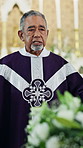 Funeral, man and pastor in church by coffin for blessing or gospel to congregation for memorial. Sermon, chapel and senior spiritual leader with preaching at burial service for religion in cathedral.