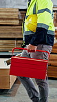 Man, hands and walk in workshop with toolbox, carpentry blueprint or woodwork manufacturing business. Carpenter, person and industrial job in factory with helmet, equipment and furniture production.
