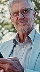 Businessman, phone and reading outdoor for thinking, notification or communication on internet. Mature person, reflection or research on tech for networking, online chat or social media in park